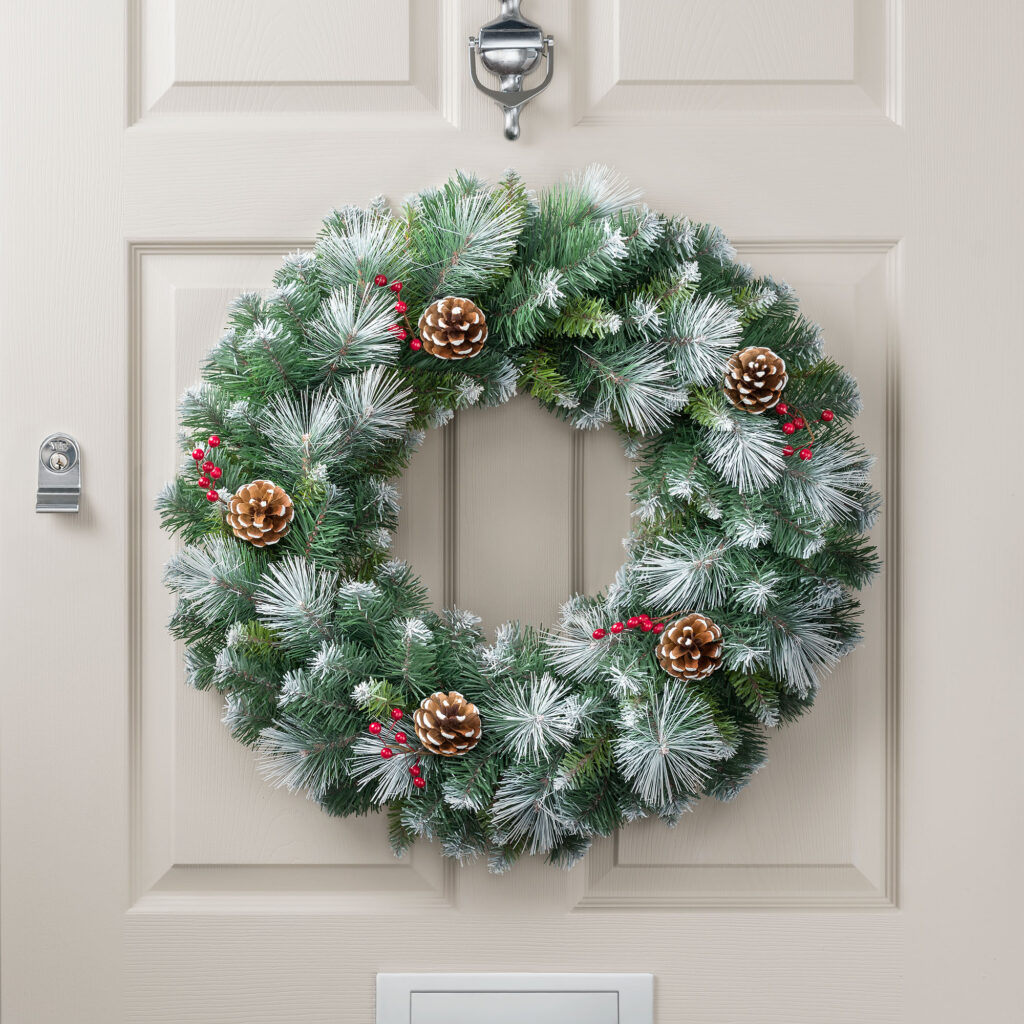 Christow Pine Cone and Berry Wreath hanging on a door.